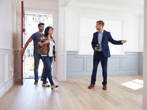 A realtor showing a new home to a couple of potential buyers.