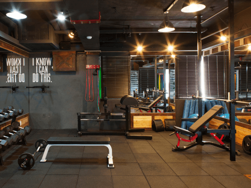 a home gym with a weight bench and different workout equpiment